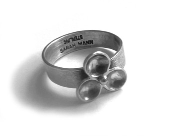 PETAL $150-sterling silver ring with mizzy texture on band and three convex petals that spin (3/16" wide band) made to size specifications